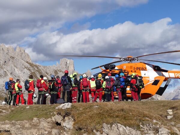 I partecipanti al corso ai piedi del massiccio del Catinaccio con l'elicottero di soccorso Pelikan 1 della HELI Elisoccorso Alto Adige.
